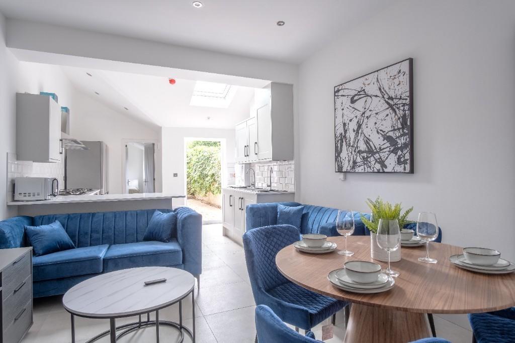 Bright and modern living room featuring comfort...