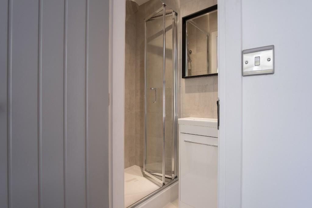 Modern bathroom featuring a sleek shower enclos...