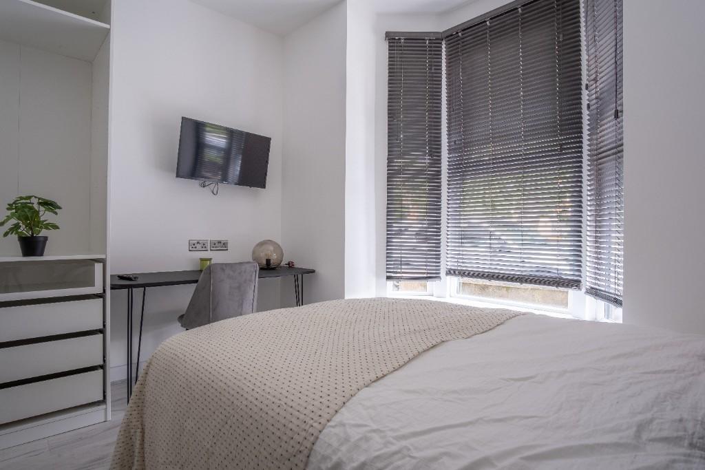 A modern double bedroom featuring a comfortable...