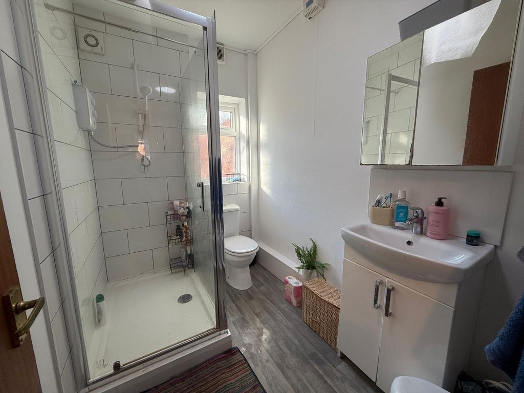Bright, modern bathroom with a corner shower cu...