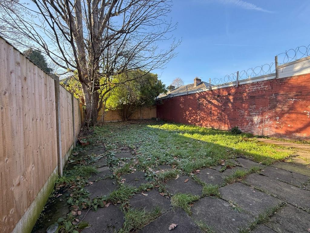 Sunny rear garden with paved patio area, mature...