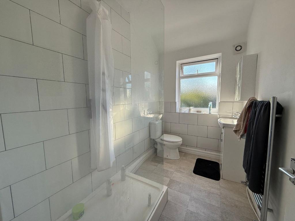 Bright, modern bathroom with white subway tiles...