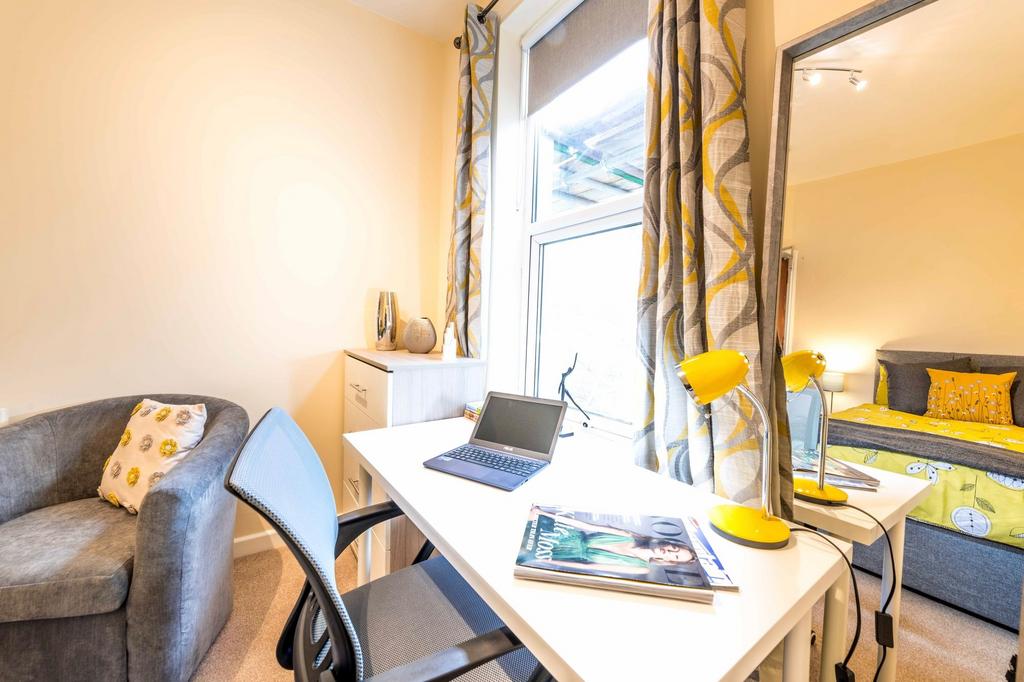 Bright, well-styled bedroom with a large window...
