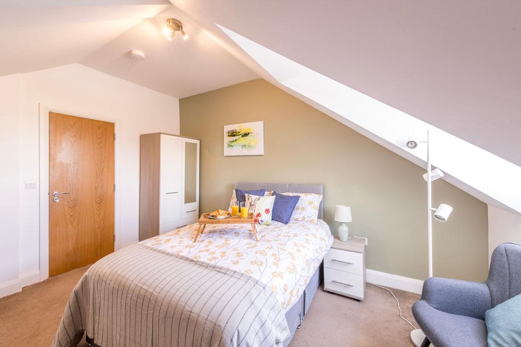 Bright, neatly presented bedroom in a loft sett...