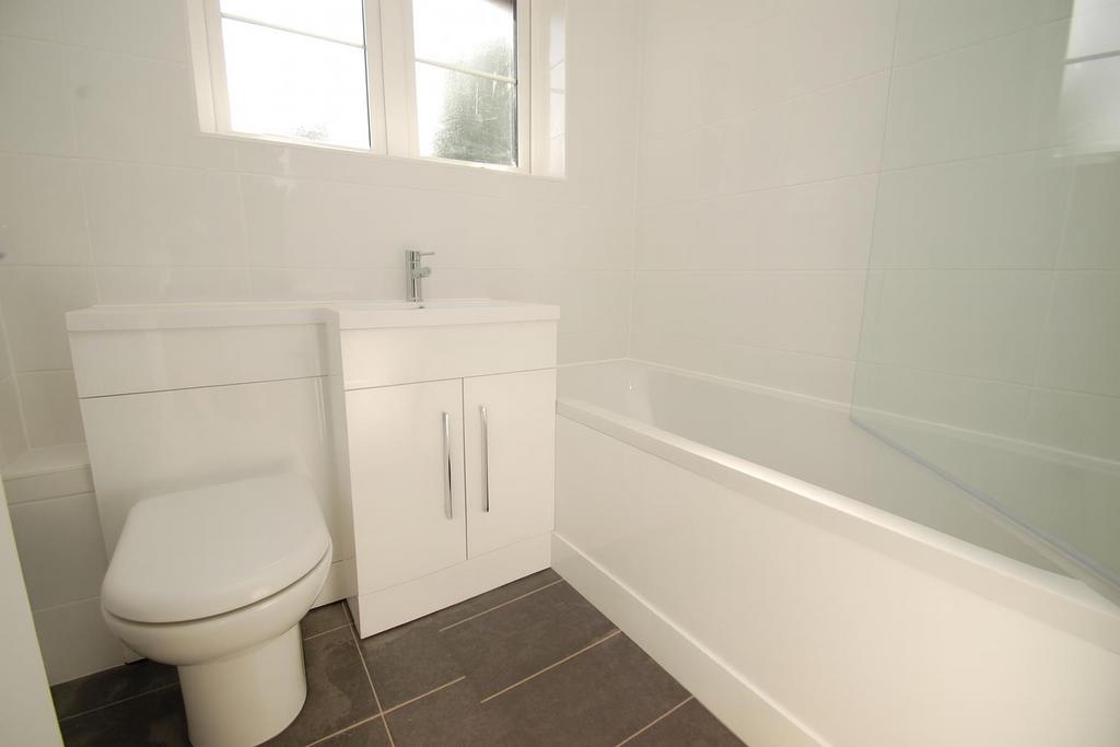 Bright White Bathroom with Modern Fixtures.png