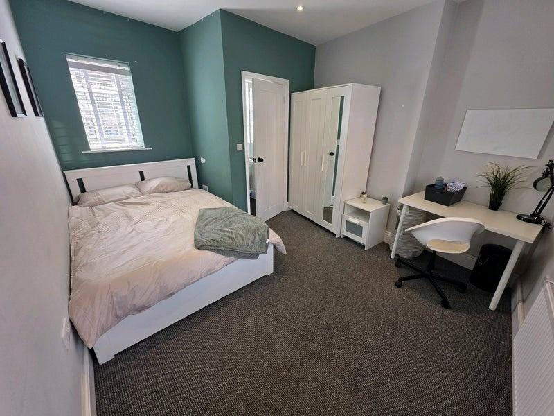 Bright and tidy double bedroom featuring a comf...