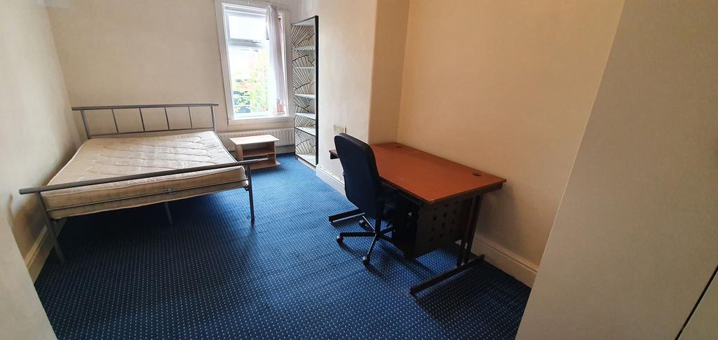 A neatly arranged double bedroom featuring a me...
