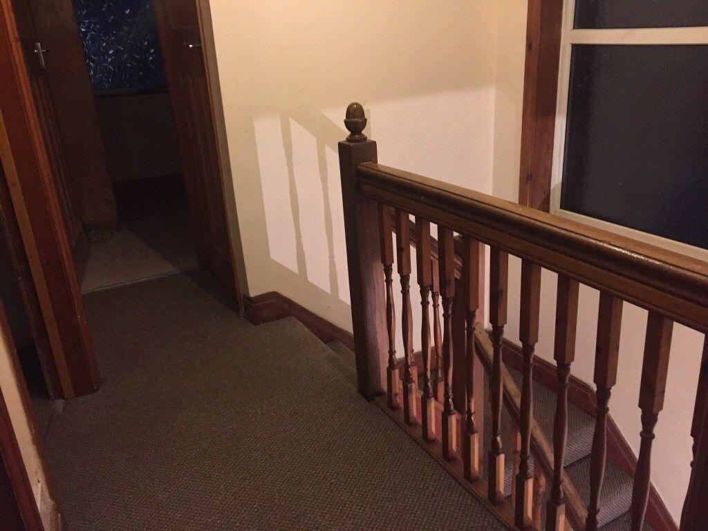 Well-maintained upstairs landing with wooden ba...