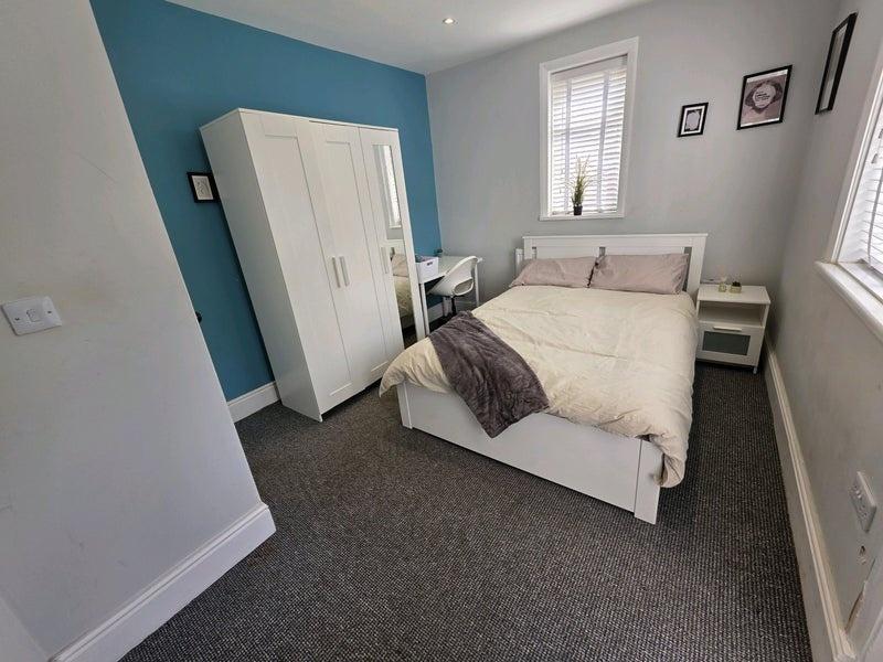 A cozy double bedroom featuring a comfortable d...