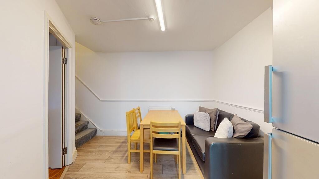 Bright, simply furnished living/dining area wit...