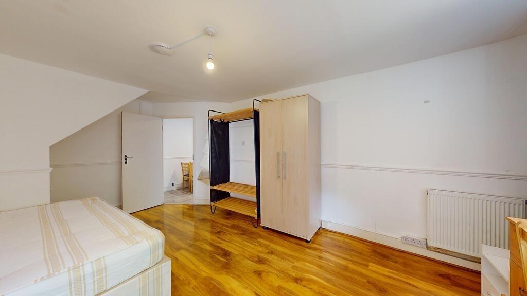 Bright, tidy bedroom with wood-effect flooring,...
