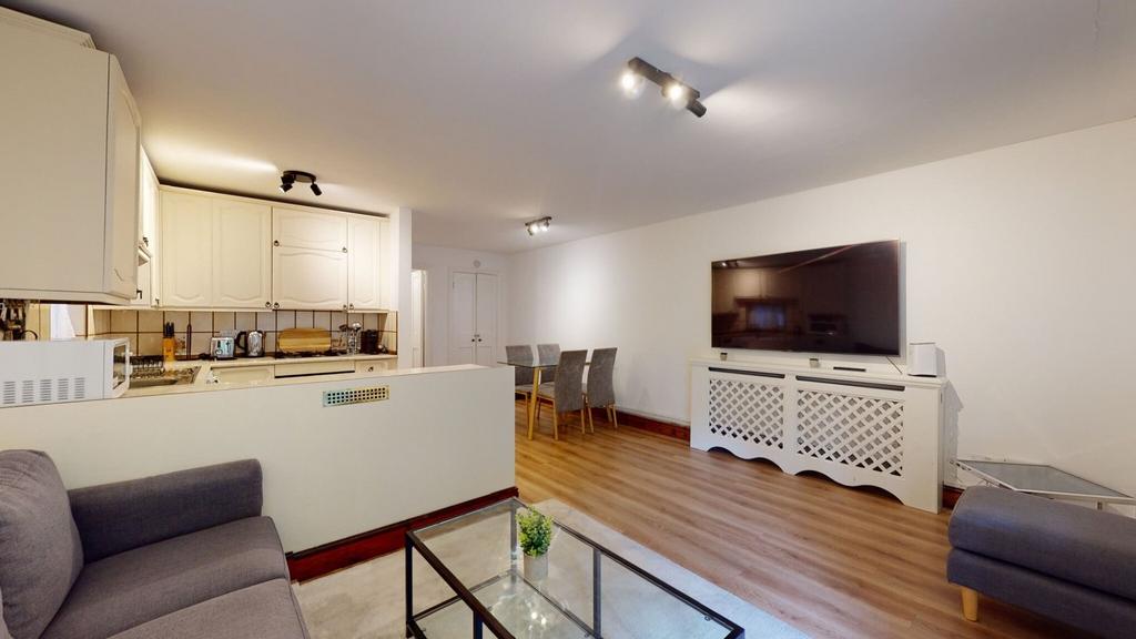 Bright, modern open-plan living area with a com...