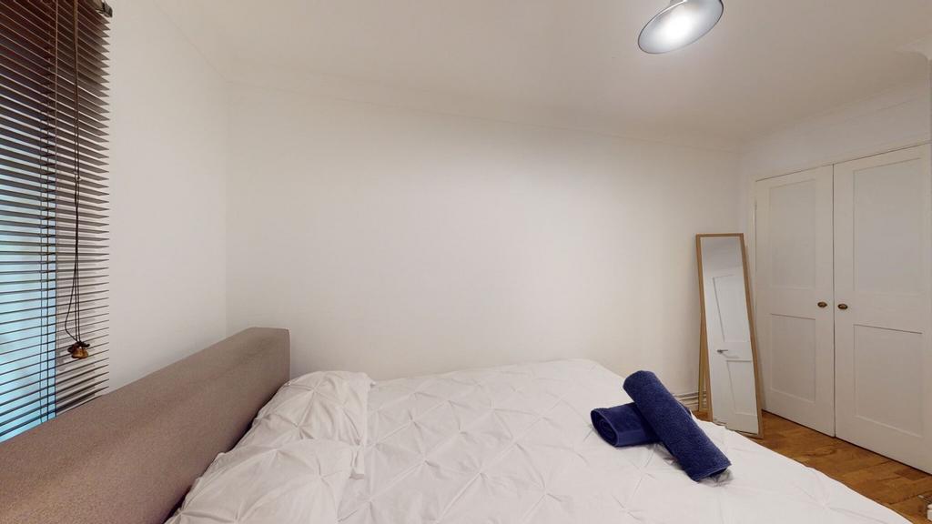Fresh, simply styled double bedroom with a neut...
