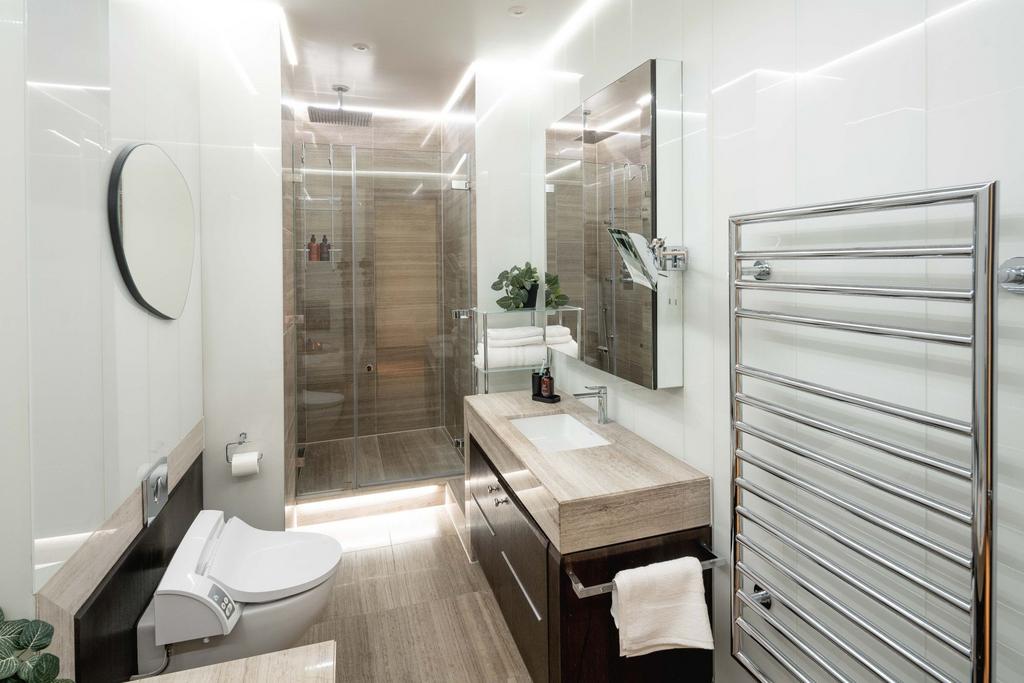 Bright, modern bathroom with a walk-in glass sh...