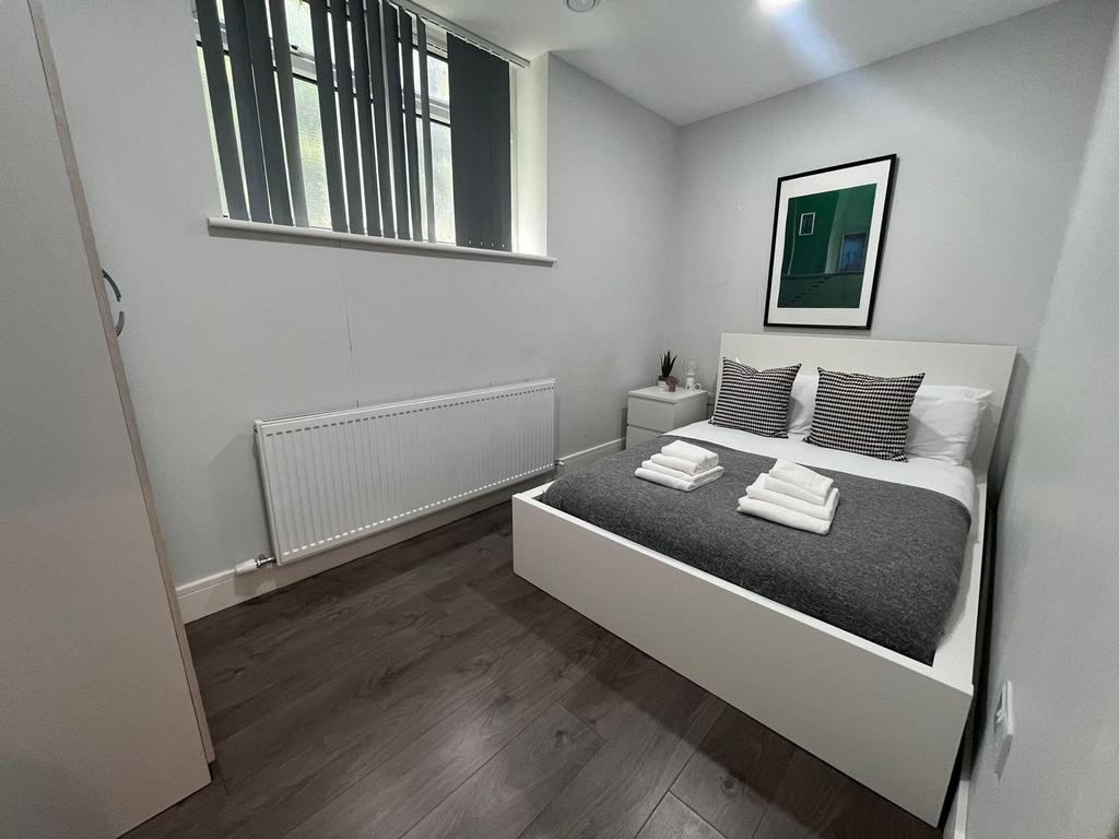 Neat, modern double bedroom with a white platfo...