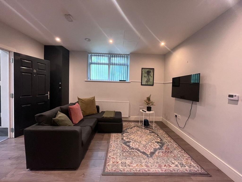 Well-presented lounge with a modern L‑shaped so...