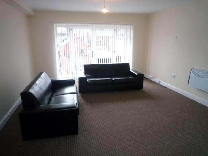 A spacious and well-lit living room featuring t...