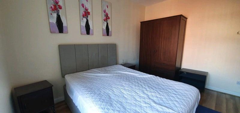 Bright, neatly presented bedroom with a comfort...