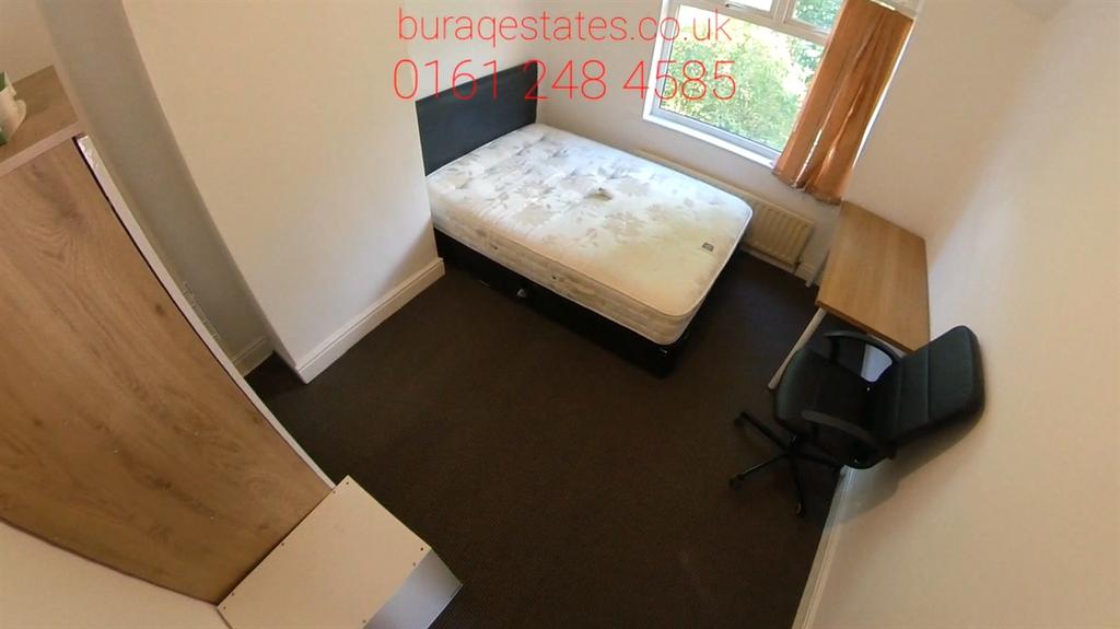 Bright single bedroom with a large window, neut...
