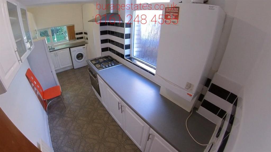 Bright galley-style kitchen with long worktop, ...
