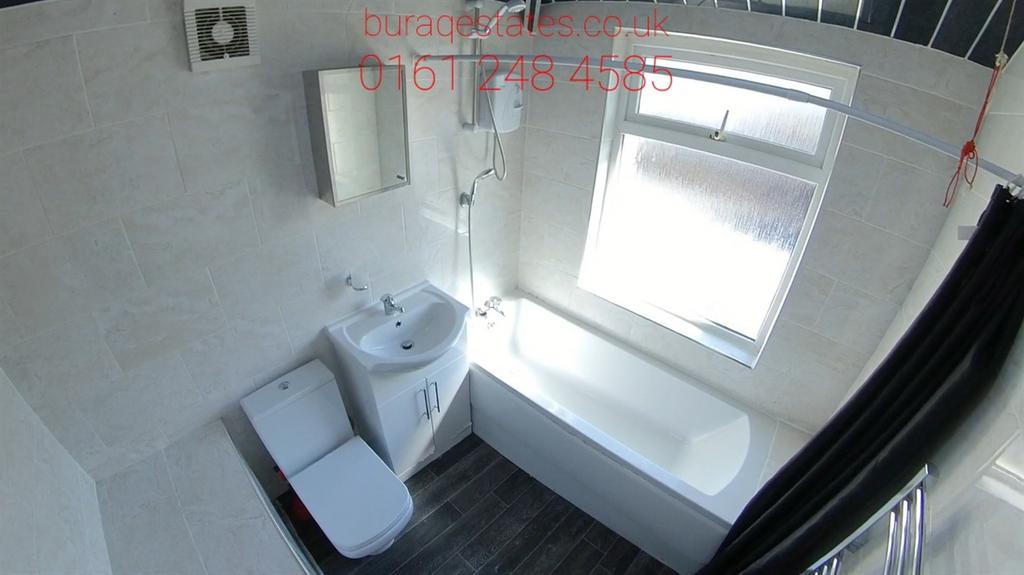 Bright, modern bathroom with white fixtures, a ...
