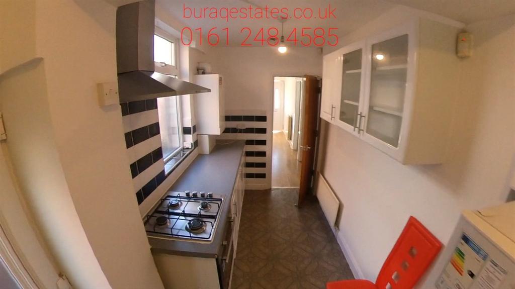 Bright galley-style kitchen with modern applian...