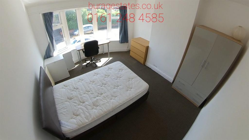 Bright bedroom with a double bed, desk by a bay...