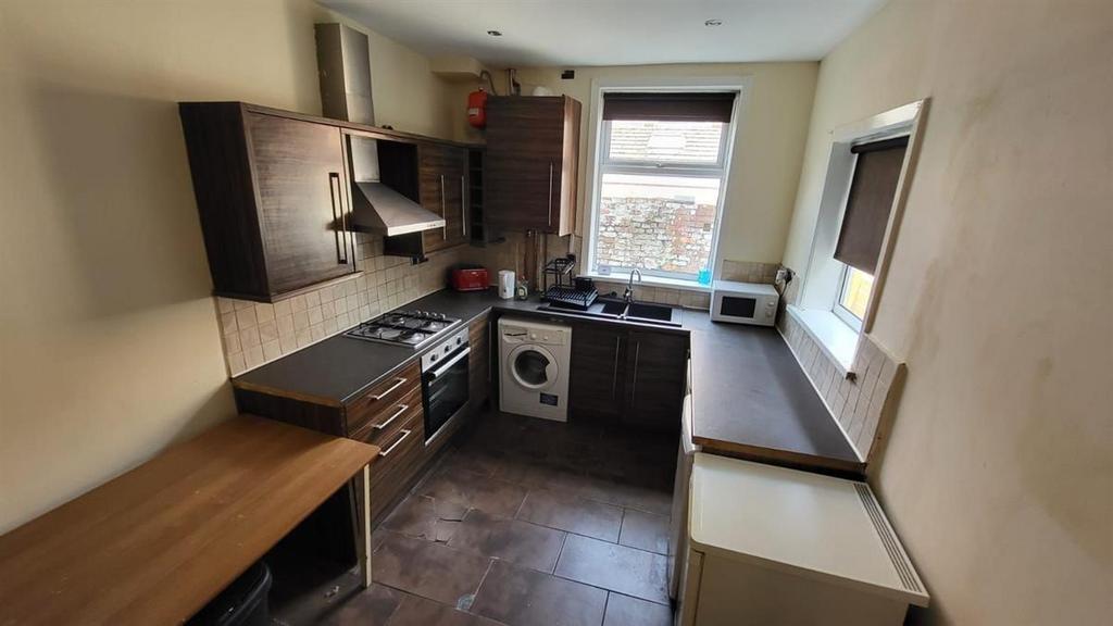 A well-lit kitchen with ample natural light fro...