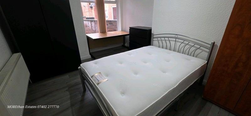 Bright, tidy double bedroom with a modern metal...