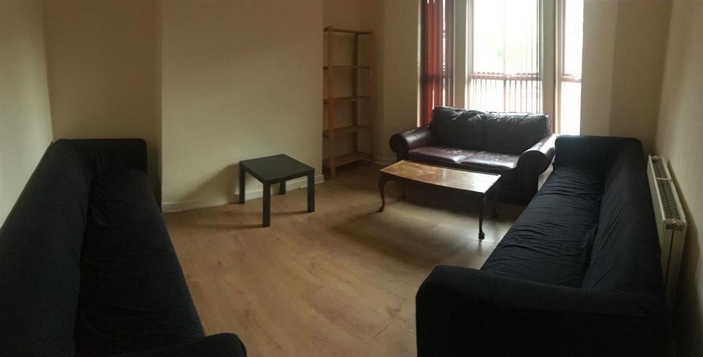Bright, simply furnished living room with match...