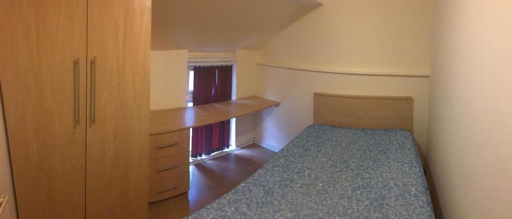 Compact, neatly presented bedroom with a fitted...