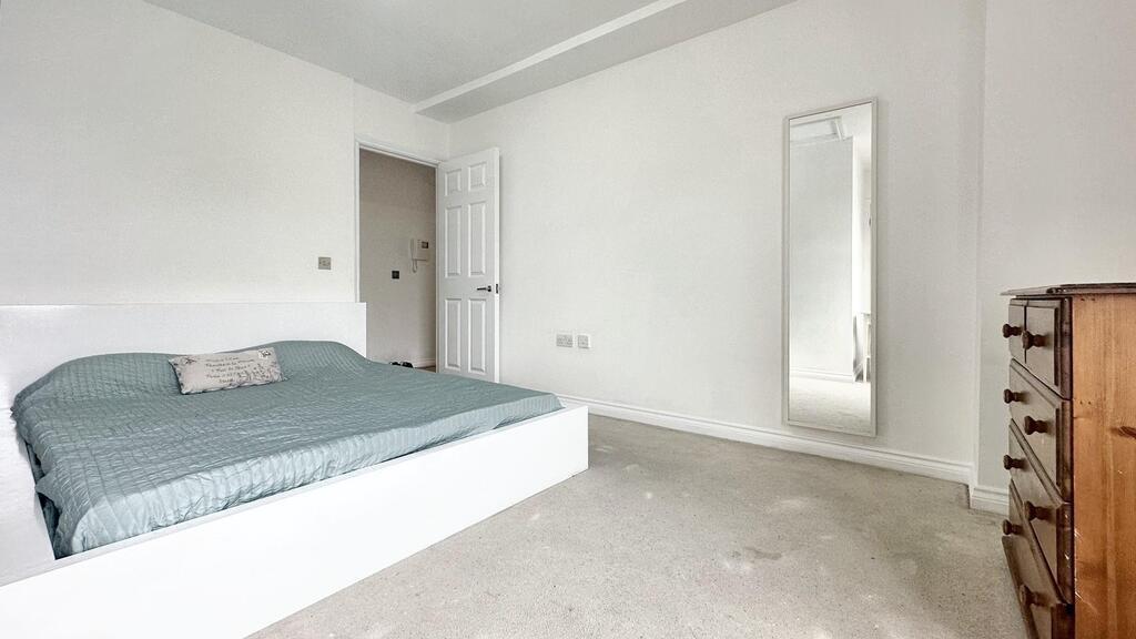 Bright, modern bedroom with a low-profile doubl...