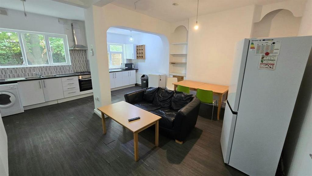 Open-plan living area with a compact lounge set...