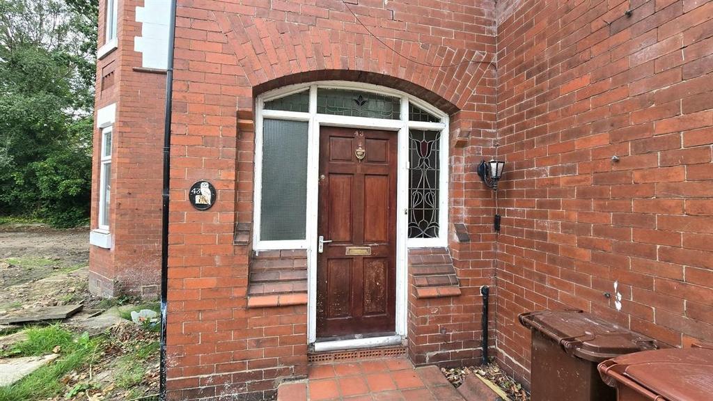Traditional red-brick house entrance with a woo...
