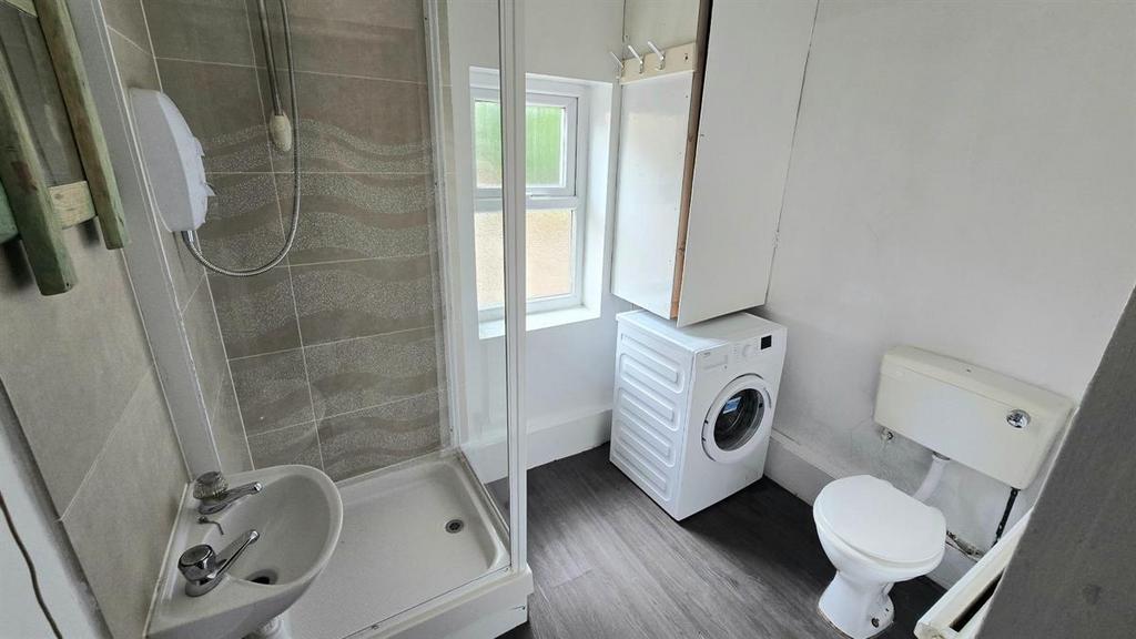 Bright, tidy bathroom with a modern shower encl...