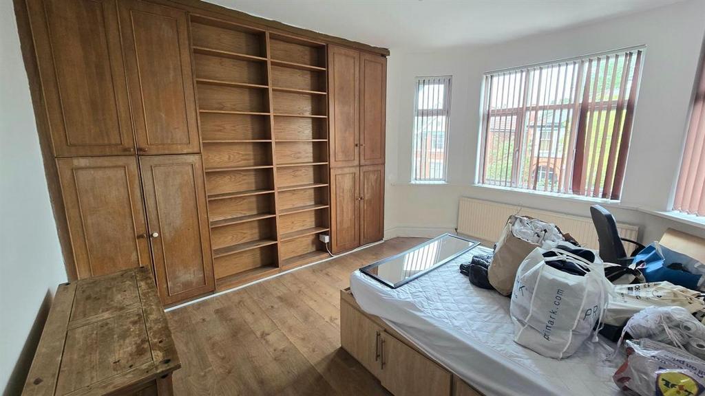 Bright double bedroom with a large fitted woode...