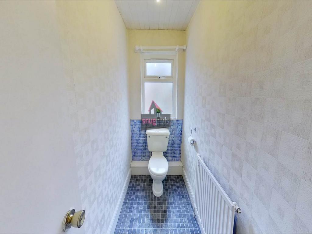 A compact, well-maintained WC with a white toil...