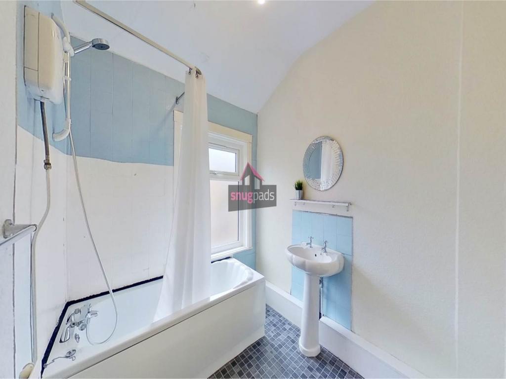 Bright, well-kept bathroom with a classic white...