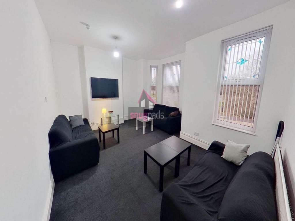 Bright, simply furnished communal lounge with m...