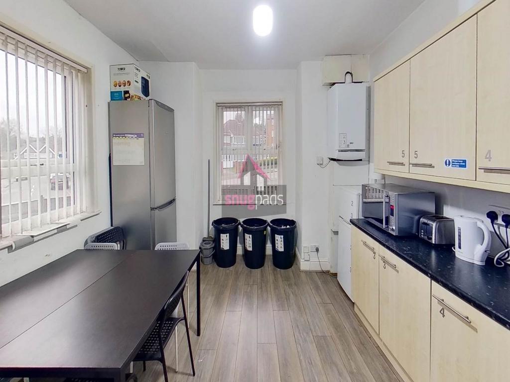Bright, modern kitchen with light wood cabinets...