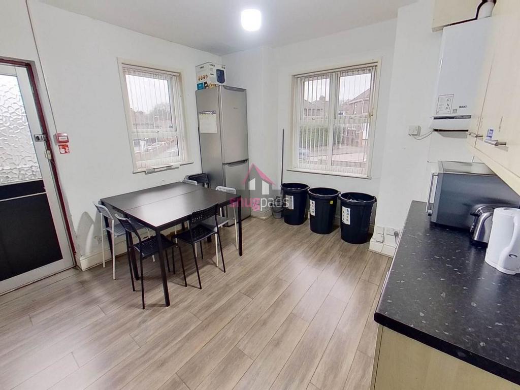 Bright communal kitchen with large windows, mod...