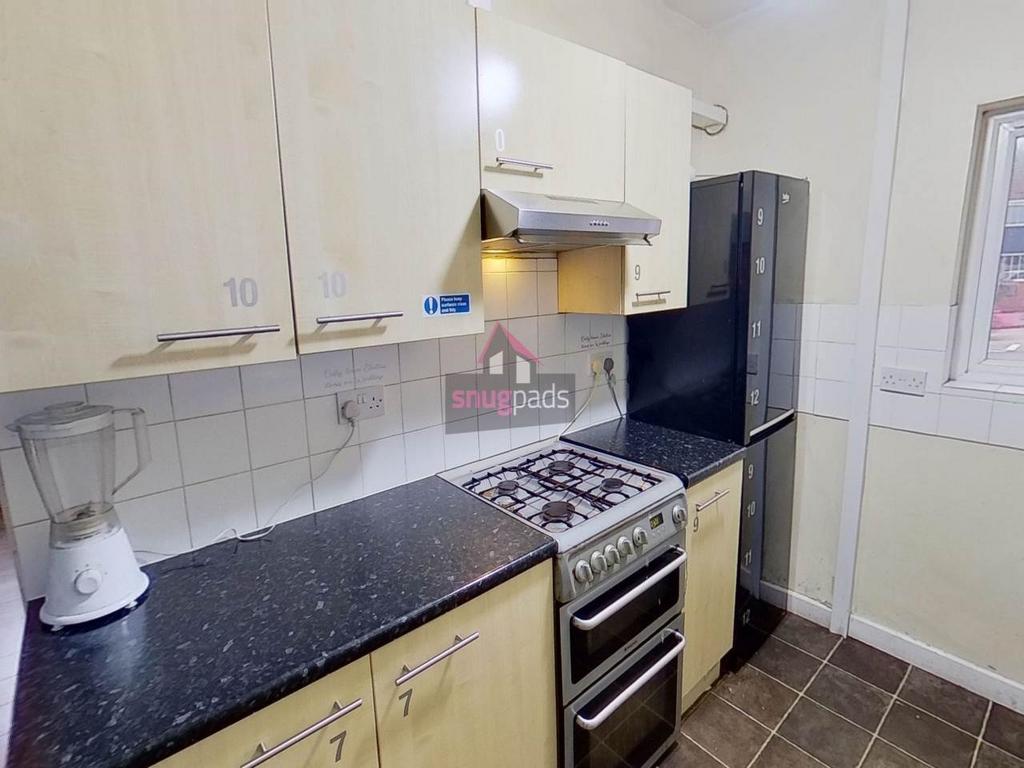 Neat galley-style kitchen with modern appliance...