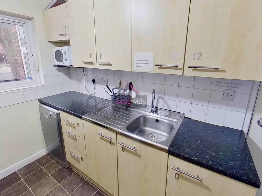 Modern fitted kitchen with light wood cabinetry...