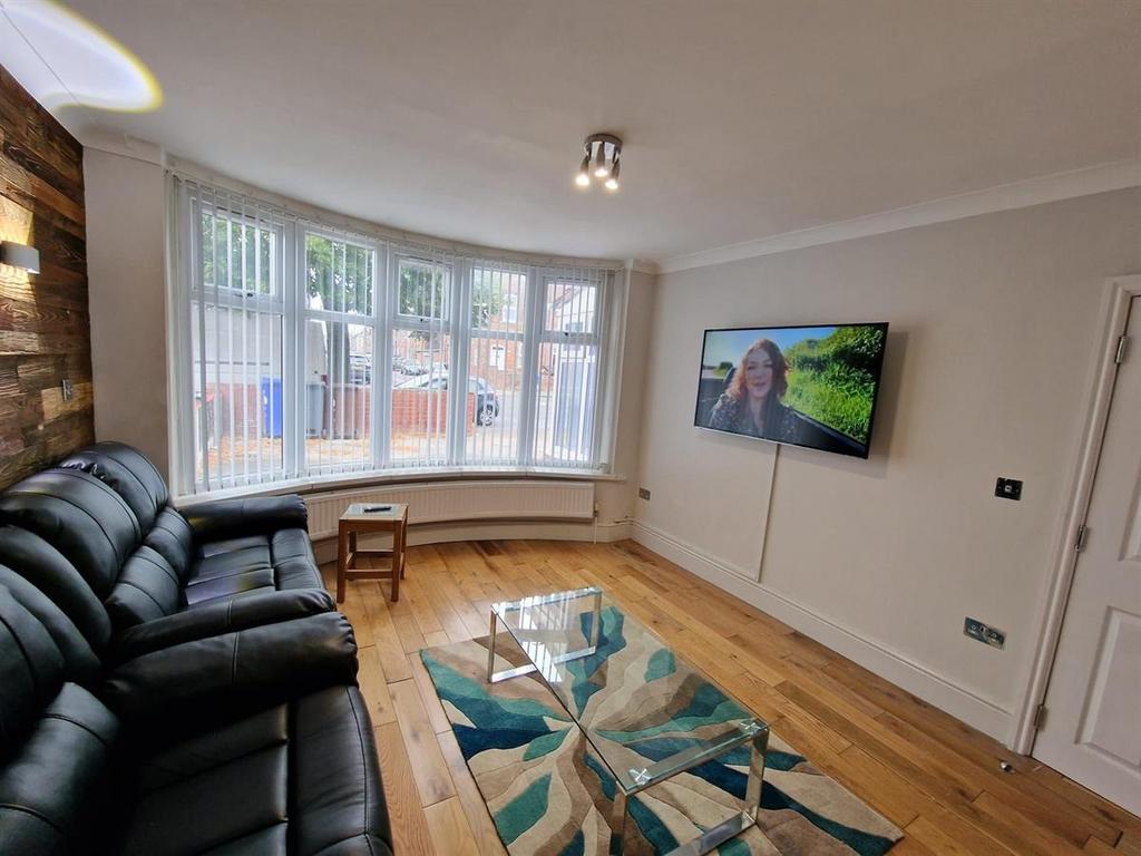 Bright, modern living room with bay window, har...