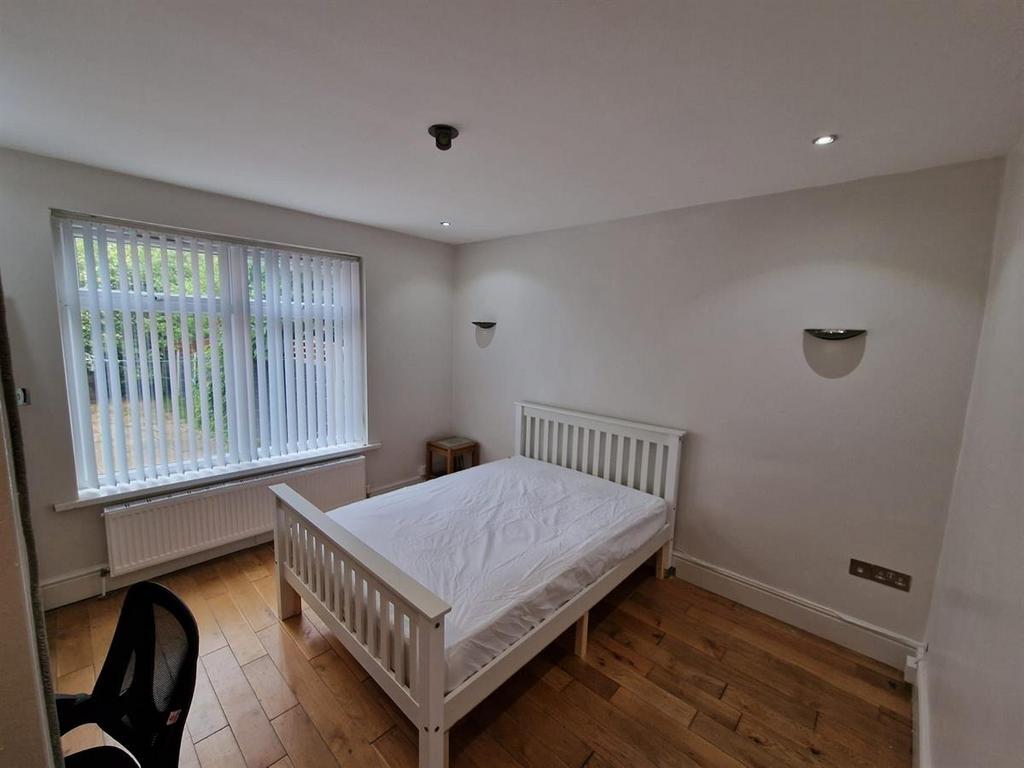Bright, tidy bedroom with a white double bed, w...