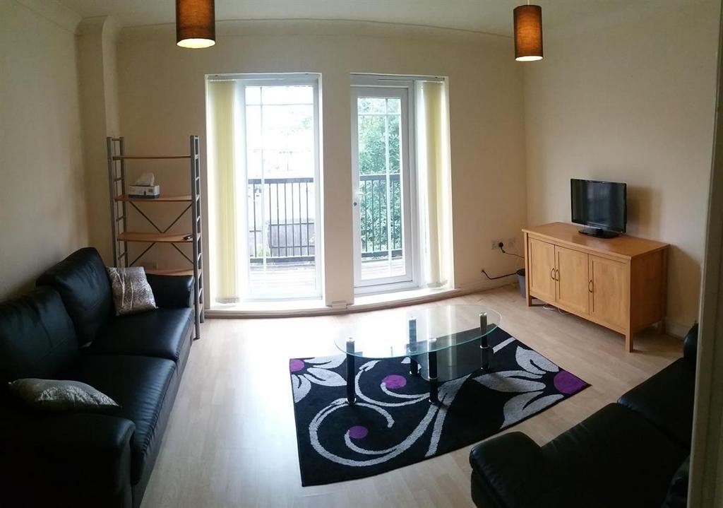 Bright, modern living room with recessed balcon...