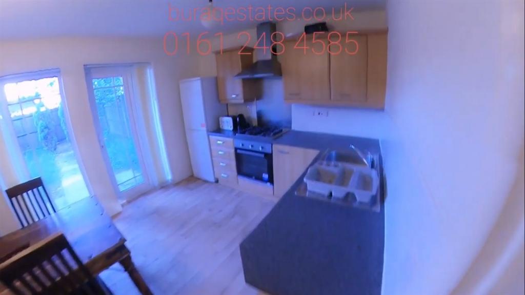 Bright open-plan kitchen with fitted units, int...