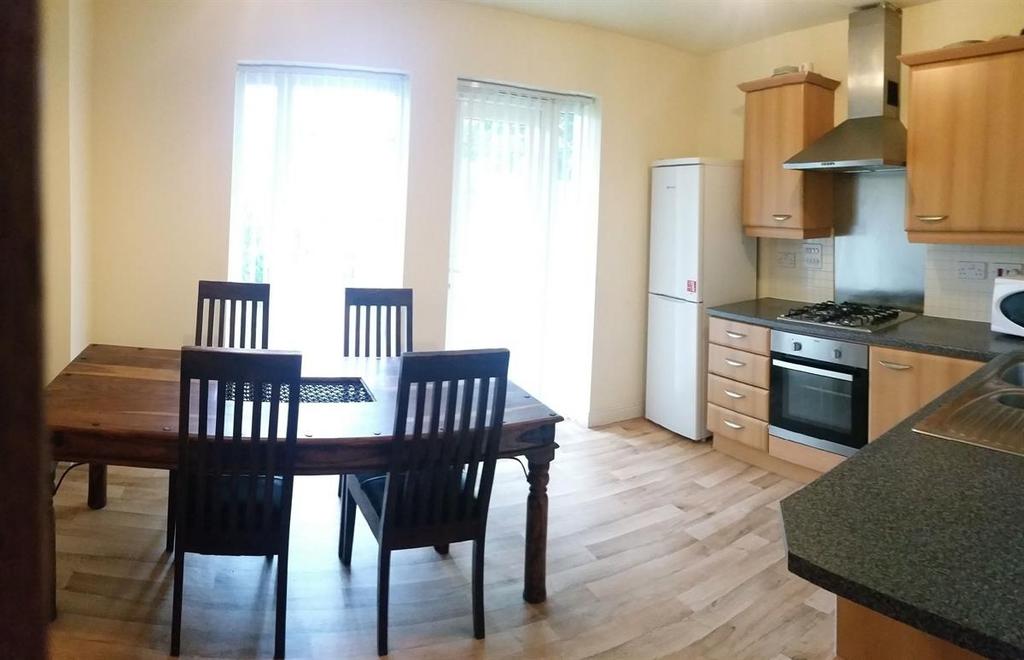 Bright open-plan kitchen with wooden cabinetry,...