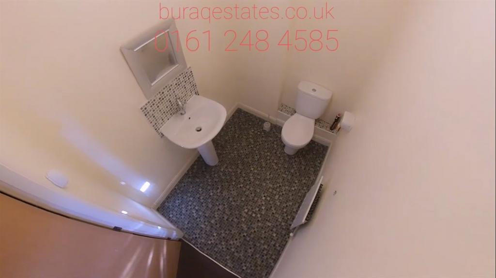 Compact, clean bathroom with a pedestal sink, t...