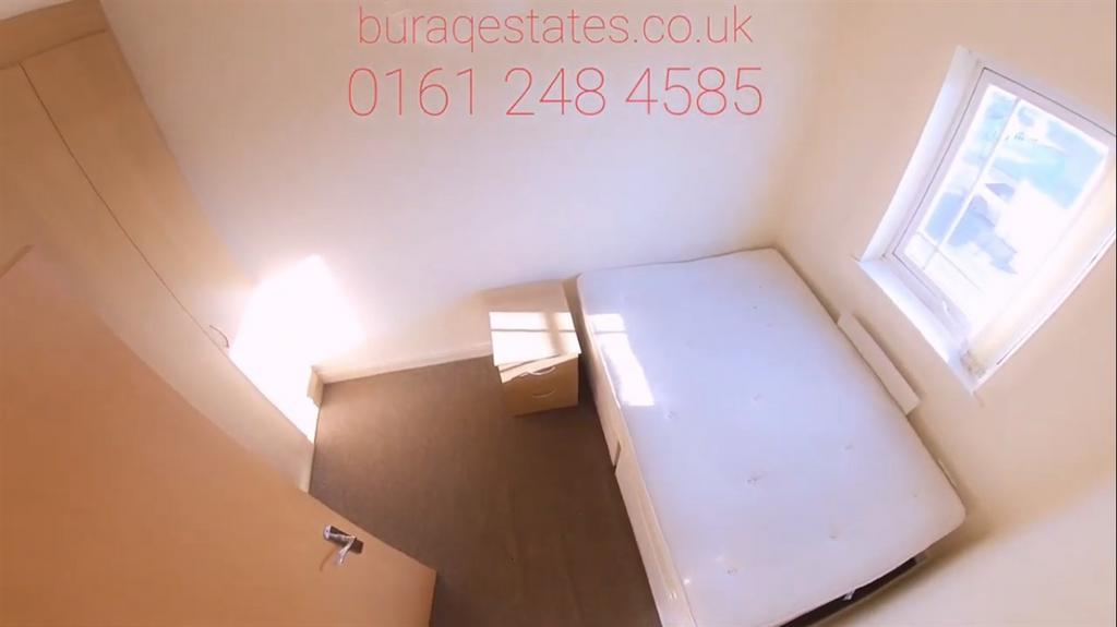 Bright single bedroom with a large window, neut...